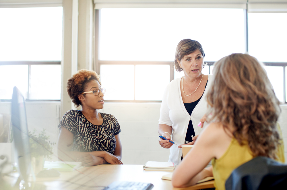 Unposed group of creative business people in an open concept office brainstorming their next project.-3